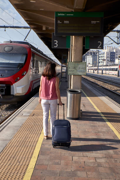 istock woman walking in a train station 1169102592