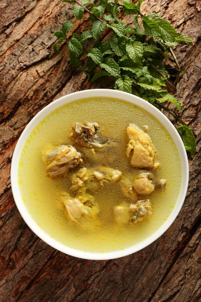 Gourmet foods- organic chicken soup Healthy diet- chicken clear soup served in ceramic bowl. chicken soup stock pictures, royalty-free photos & images