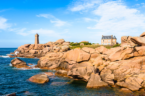 Landscape on the Pink Granite Coast in northern Brittany on the municipality of Perros-Guirec, France, with the Ploumanac'h lighthouse, named Mean Ruz and made of the same pink granite.
