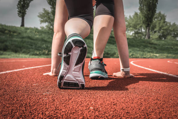 istock Athlete woman at starting line ready to run 1169107123
