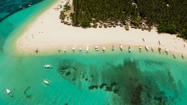 istock Tropical Daco Island with a sandy beach and tourists 1169107276