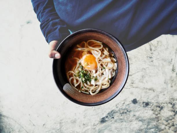 Selfie of ramen noodle soup with hand