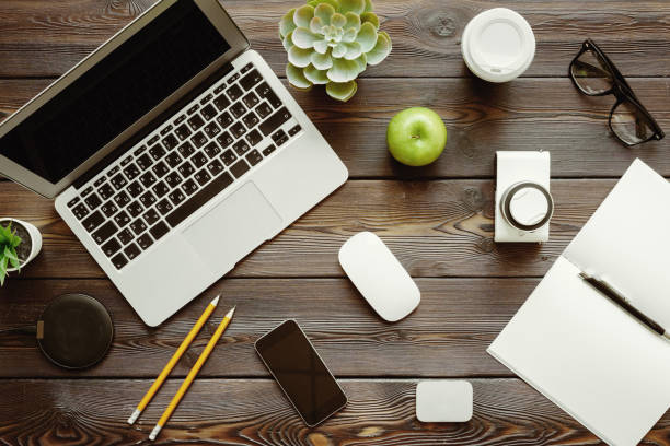 istock Office desk with laptop computer, supplies and green apple, top view 1169112036