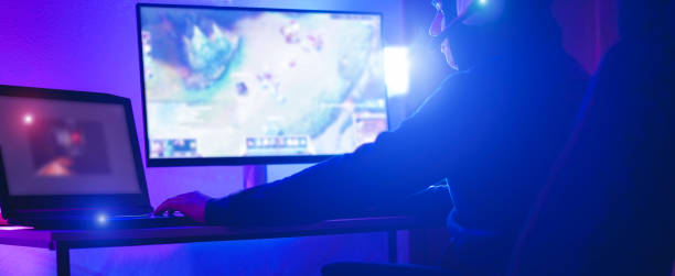 istock Young streamer gamer playing at strategy game in broadcast browser - Male guy having fun gaming and streaming online - New technology game trends and entertainment concept - Soft focus on his hand 1169113638