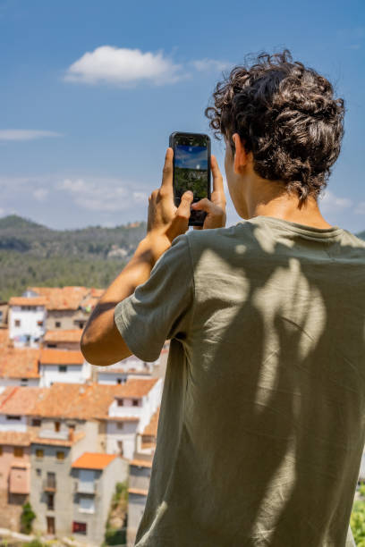 istock Young man photographing 1169114562