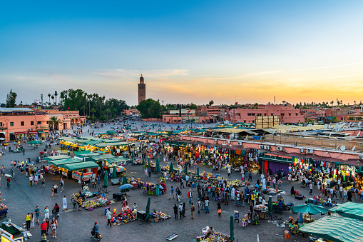 Shopping arcades on Jemaa el-Fna Marrakech market. Merchants sell various goods to tourists and locals.