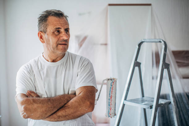 istock Mature man house painter with arms crossed 1169115956