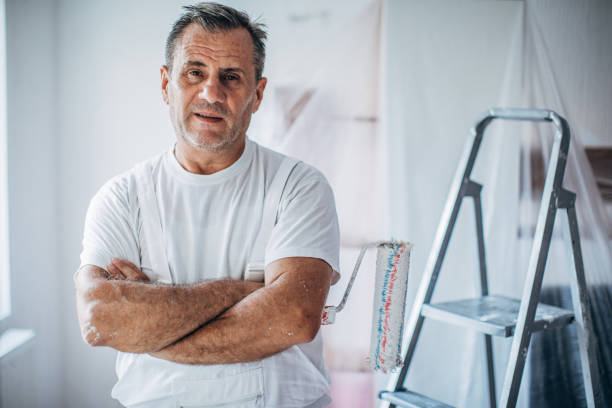 istock Mature man house painter with arms crossed 1169116048