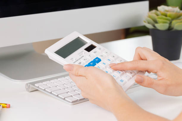 istock woman hands working with calculator close up 1169118453