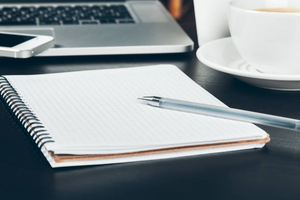 istock Pen and notebook up close on an office desk 1169119003