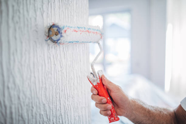 istock House painter painting a wall 1169122760