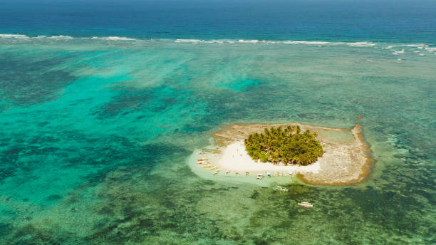 istock Tropical Guyam Island with a sandy beach and tourists 1169125544