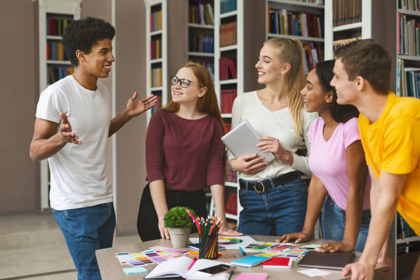 istock Group of young designers discussing about project 1169126588