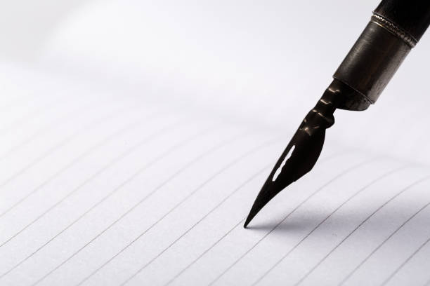 istock diary with fountain pen on white close-up 1169129441