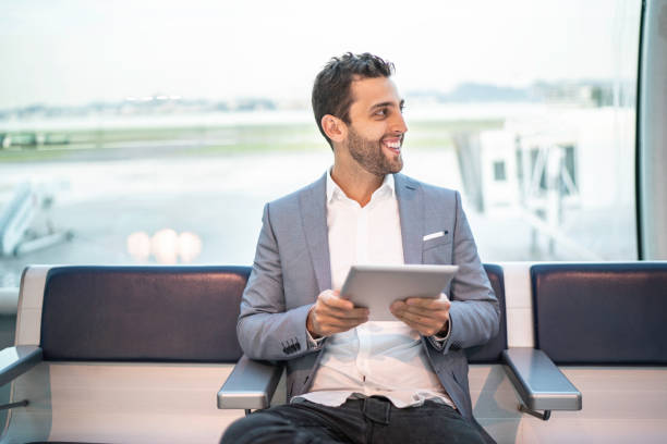 istock Businessman waiting and using tablet on airport 1169130687