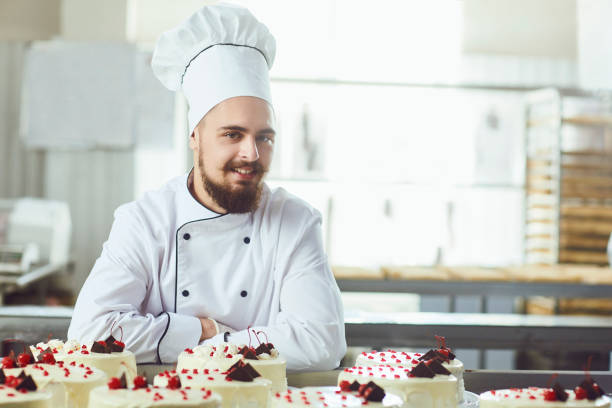 istock Pastry man smiling in a pastry shop 1169130833