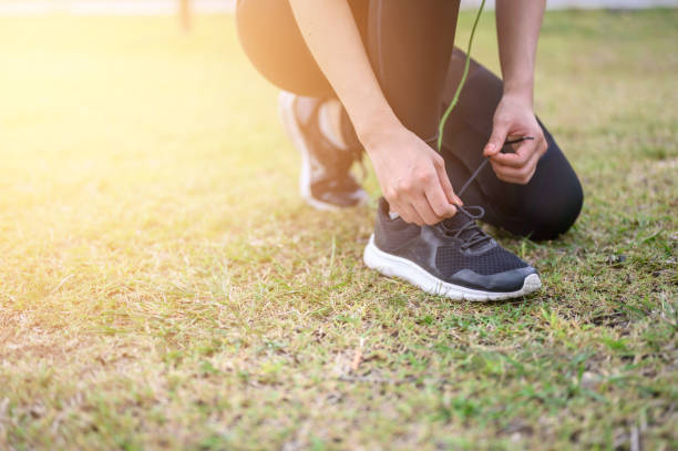 istock Female runners are sitting in a shoe strap ready for running. 1169132922
