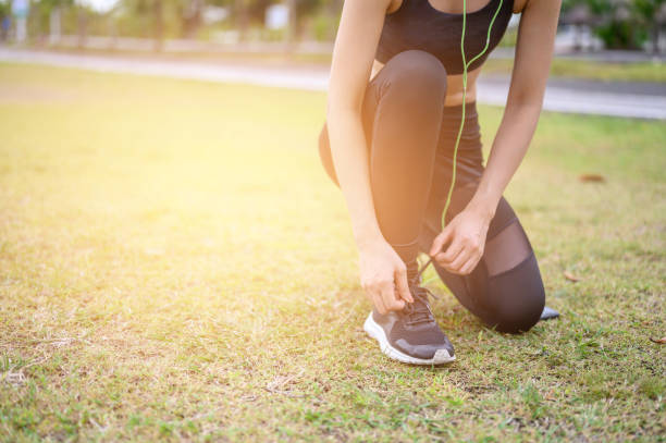 istock Female runners are sitting in a shoe strap ready for running. 1169132943