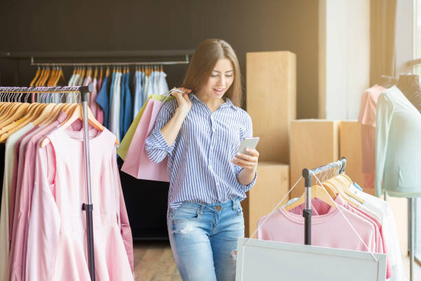 istock Surprised shopping woman with bags chatting on smartphone 1169133473