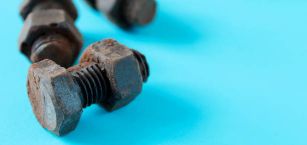 istock Rusty bolts and nuts made of chocolate isolated on sky blue background 1169133530