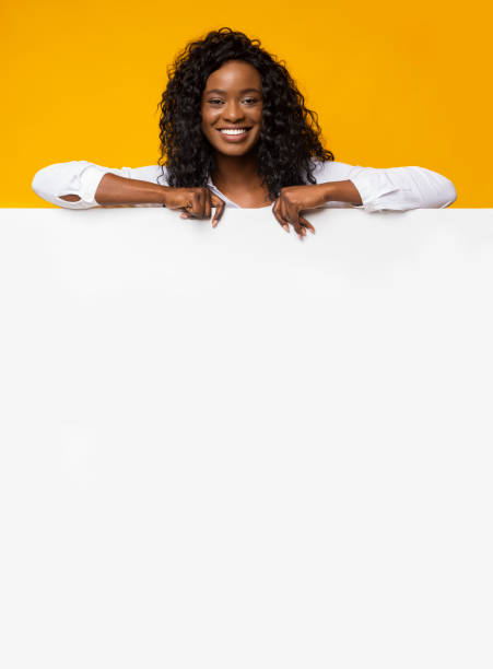 istock Black Pretty Girl Leaning On White Board 1169134199