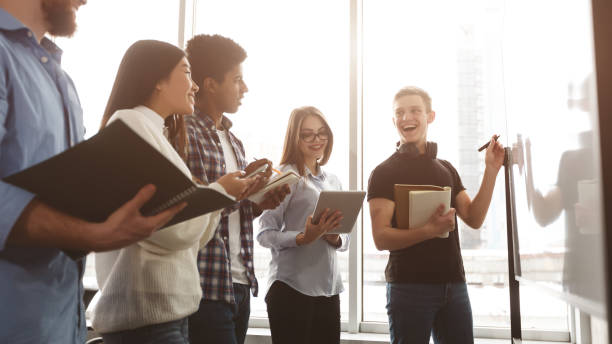 istock Students writing assignments on whiteboard in classroom 1169134463