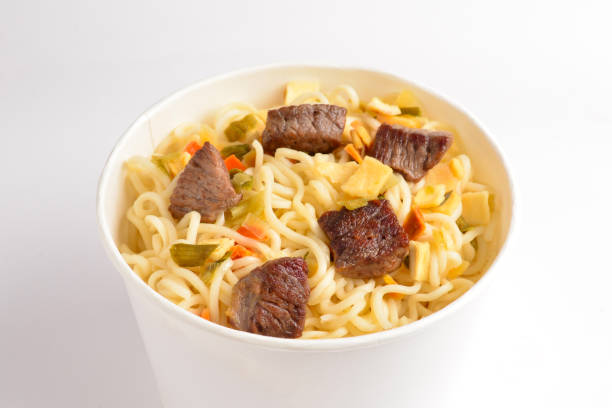 istock Paper cup with instant ramen noodles with beef and vegetables. 1169134714