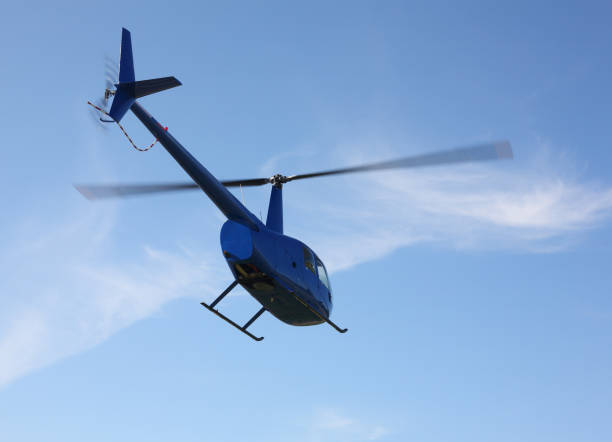 istock The aircraft - Blue small helicopter makes flight low  height 1169135059
