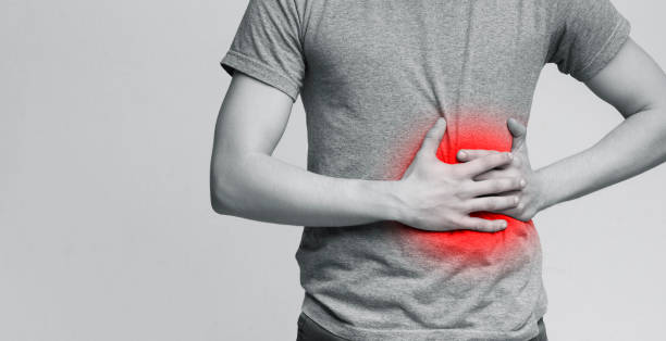 istock Troubled man touching left side, suffering from strong stomach ache 1169135853