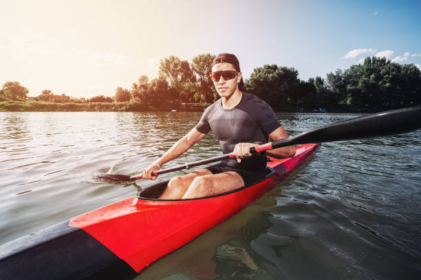 istock Sportsman kayaking on a lake while the sun setting 1169135950