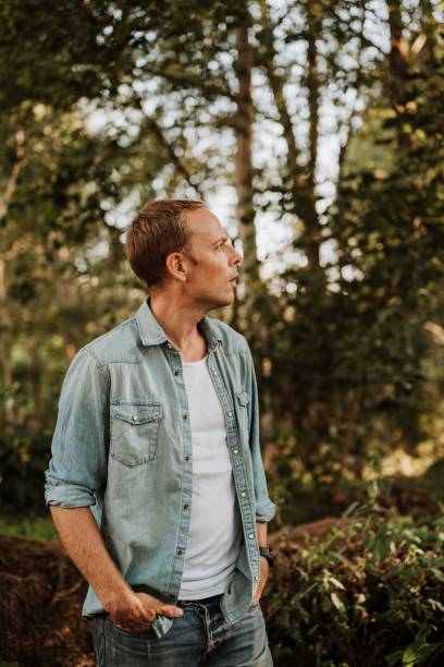 istock Man walking in green nature 1169136250