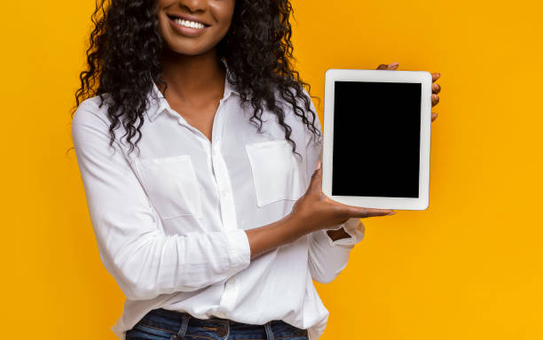 istock Afro woman showing blank digital tablet screen 1169136256