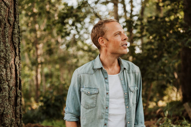 istock Man walking in green nature 1169136259
