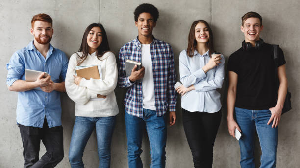 istock Education concept. Students smiling to camera over grey wall 1169136412