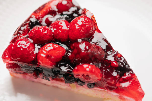 istock Piece of cake with berries: raspberry, strawberry, currant, on a white background, close-up, top view 1169136469