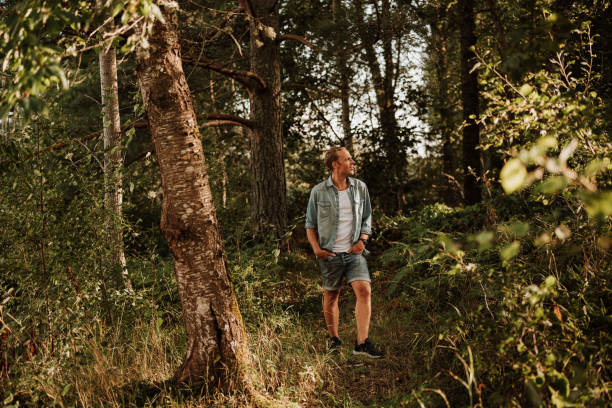 istock Man walking in green nature 1169137027