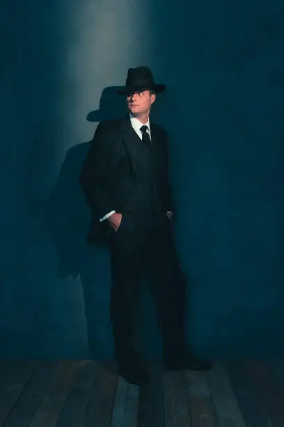 Photo of Retro man in hat wears suit and tie.