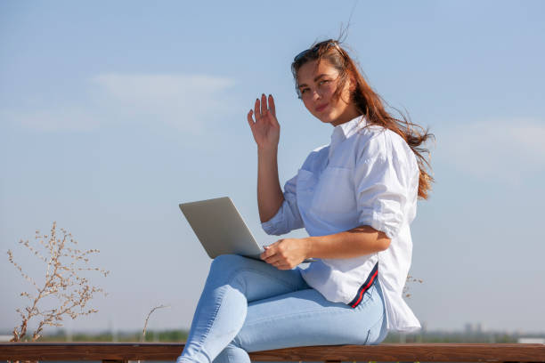 istock Working on something with a laptop in a public park 1169137524