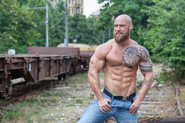 Powerful guy Powerful shirtless male posing on the rail station chest tattoos for men designs stock pictures, royalty-free photos & images