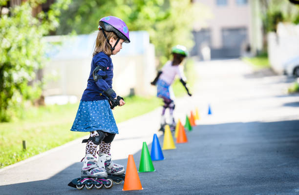 istock Children learning to roller skate on the road with cones. 1169140036