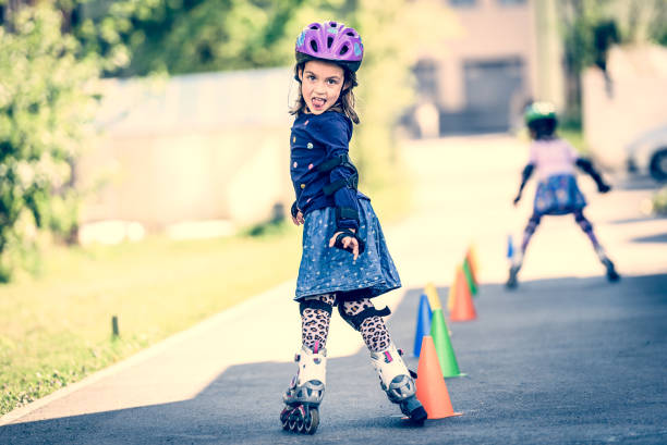 istock Children learning to roller skate on the road with cones. 1169140040
