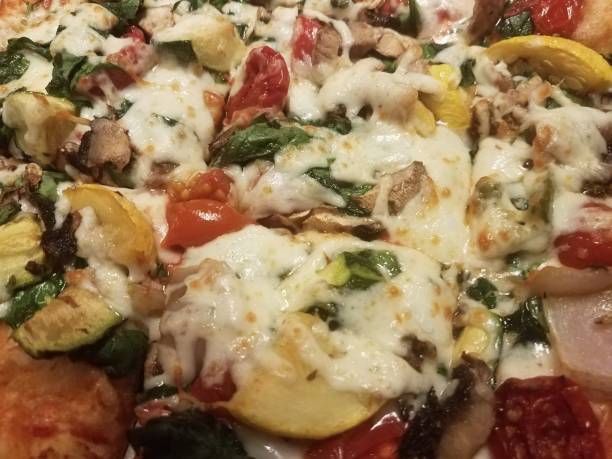 istock colorful pizza with cheese vegetables tomatoes up close 1169141675