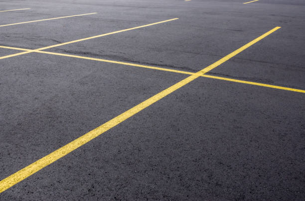 Freshly Paved Parking Lot A freshly paved asphalt parking lot in Michigan. freshly painted road markings stock pictures, royalty-free photos & images