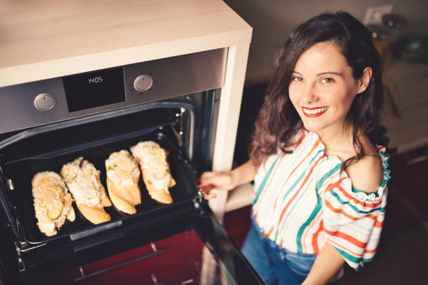 istock Beautiful woman in her kitchen 1169141912
