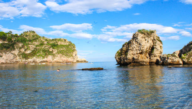 Rocky island framed by lush Mediterranean vegetation