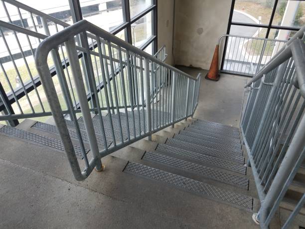 istock cement stairs or steps with railing and orange cone 1169144155