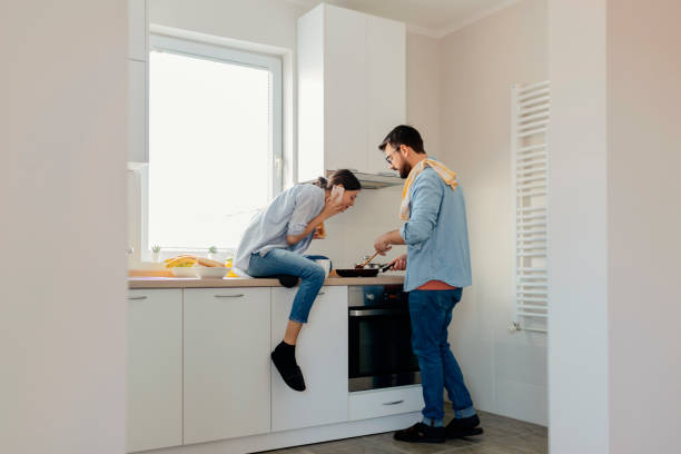 istock Couple Cooking Together in the Kitchen 1169144527