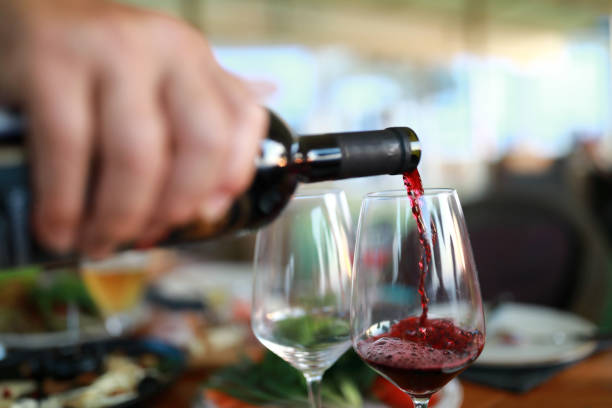 istock Man pouring red wine 1169145522