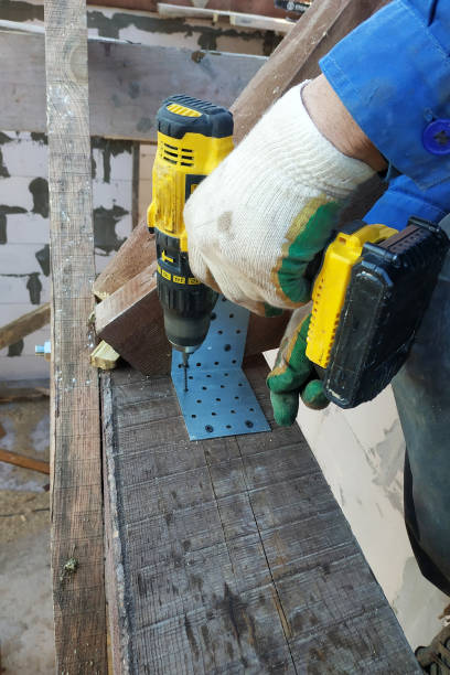 istock master screwdriver screwdriver screw into a wooden board 1169150232