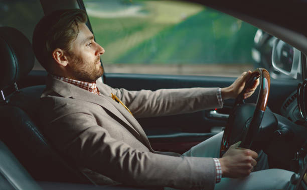 istock Businessman enjoying new car 1169151288